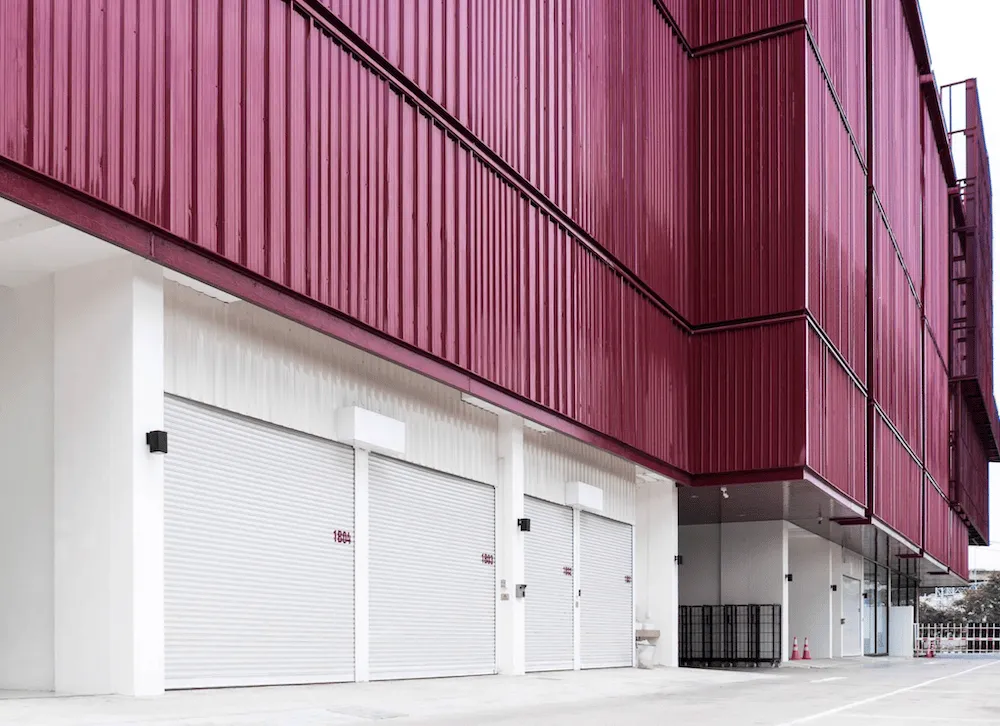 REDD Suan Luang loading bay with white roller-shutter drive-up units